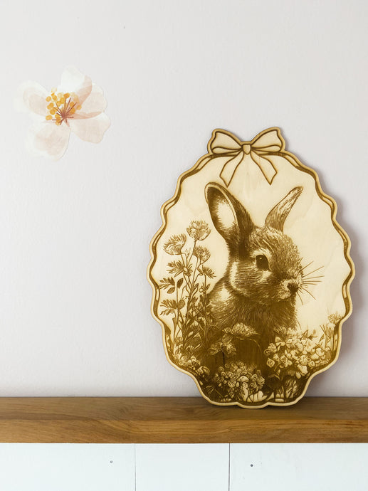 An intricately engraved bunny amongst wildflowers image on wood